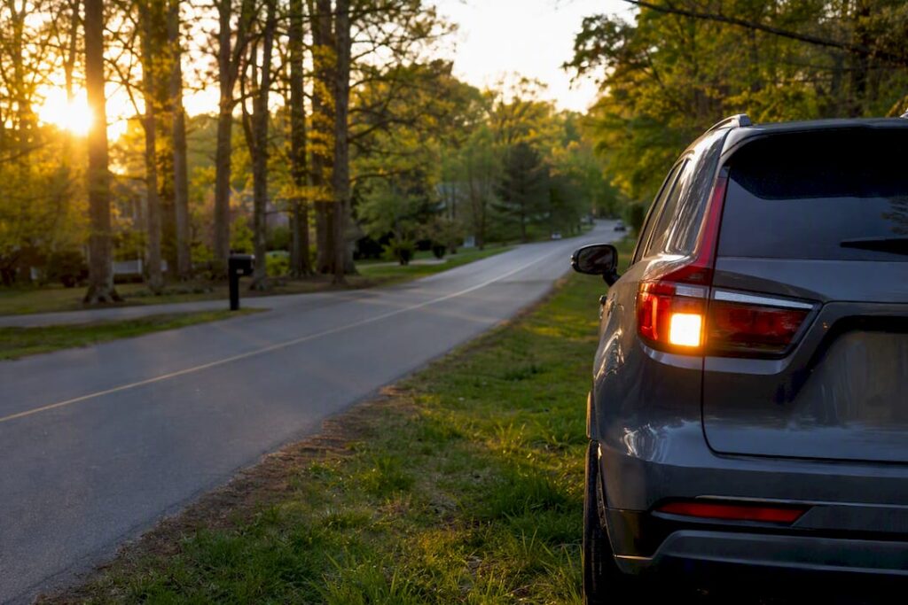 Car with hazard lights flashing on roadside