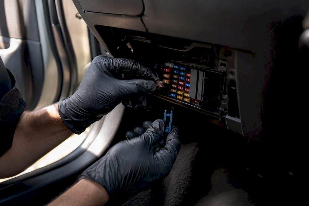 Mechanic checking an automotive fuse panel